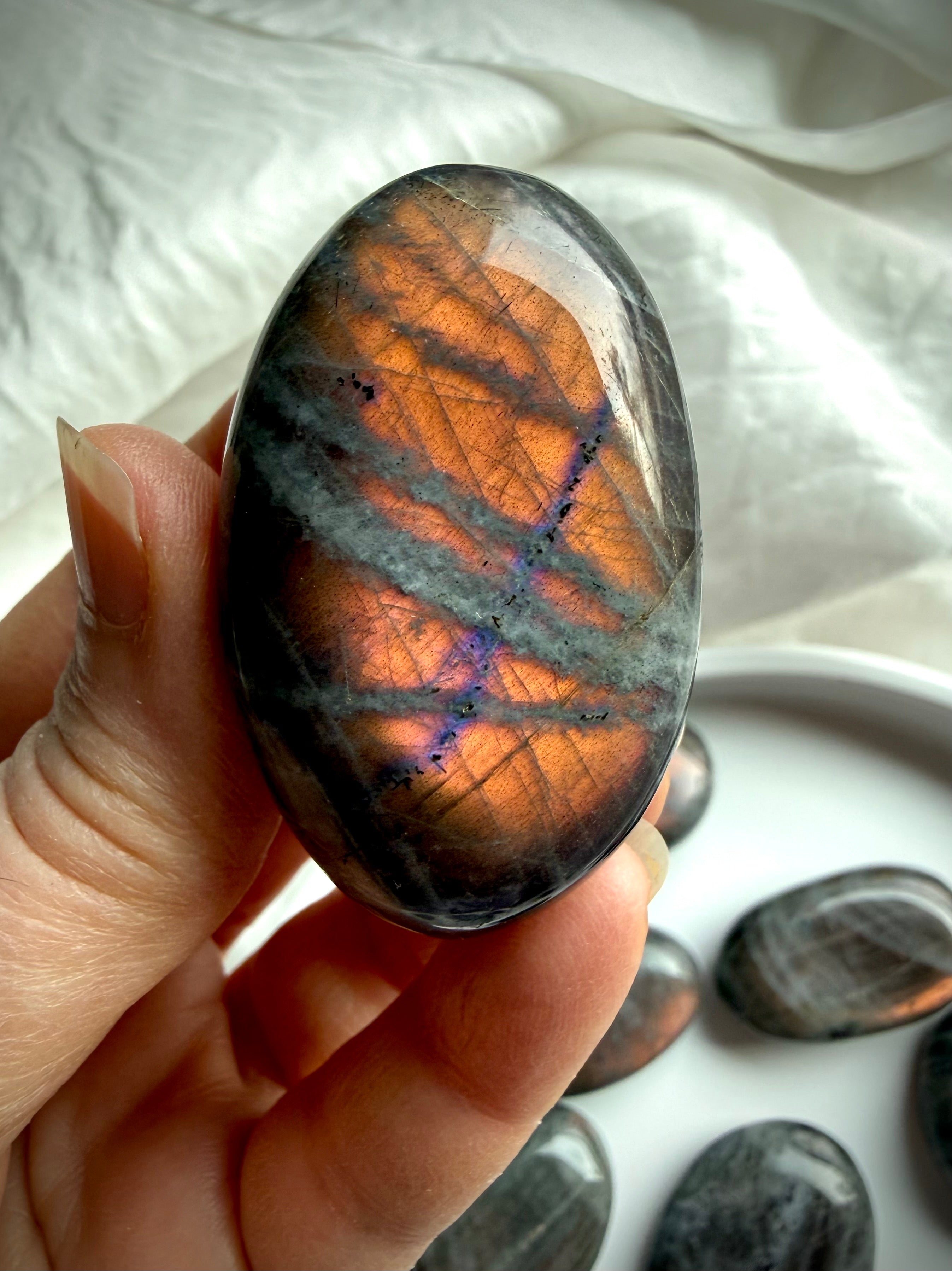 Peach Sunset Labradorite palm stone with orange flash and subtle violet undertones
