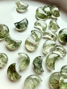 Green Tourmaline Quartz moon carvings showing variations in translucence, green inclusions and natural crystal patterns