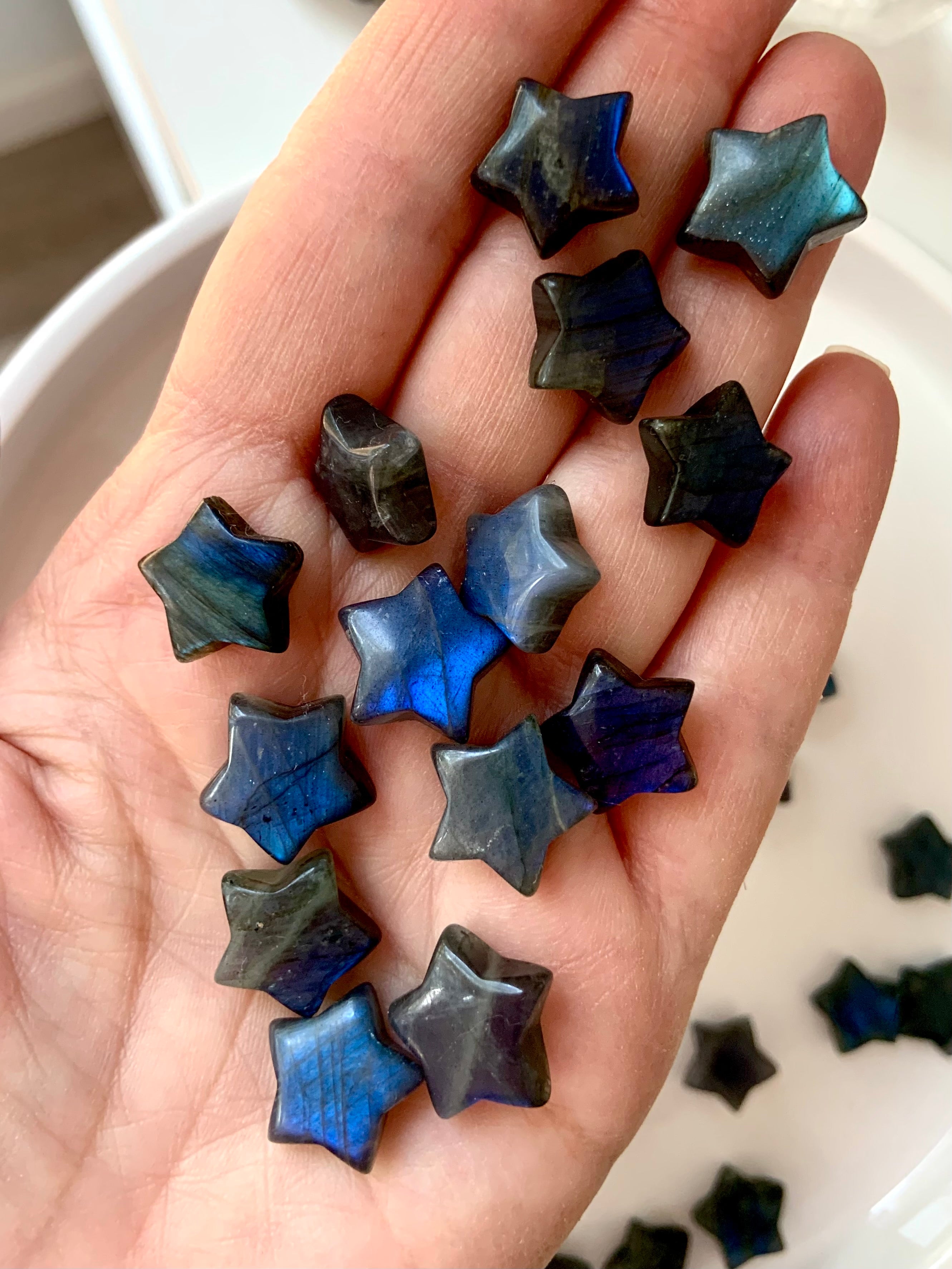 Deep blue Labradorite crystal stars shown in hand — pocket-sized mini carvings for intuition, Third Eye healing &amp; high-vibration energy work.