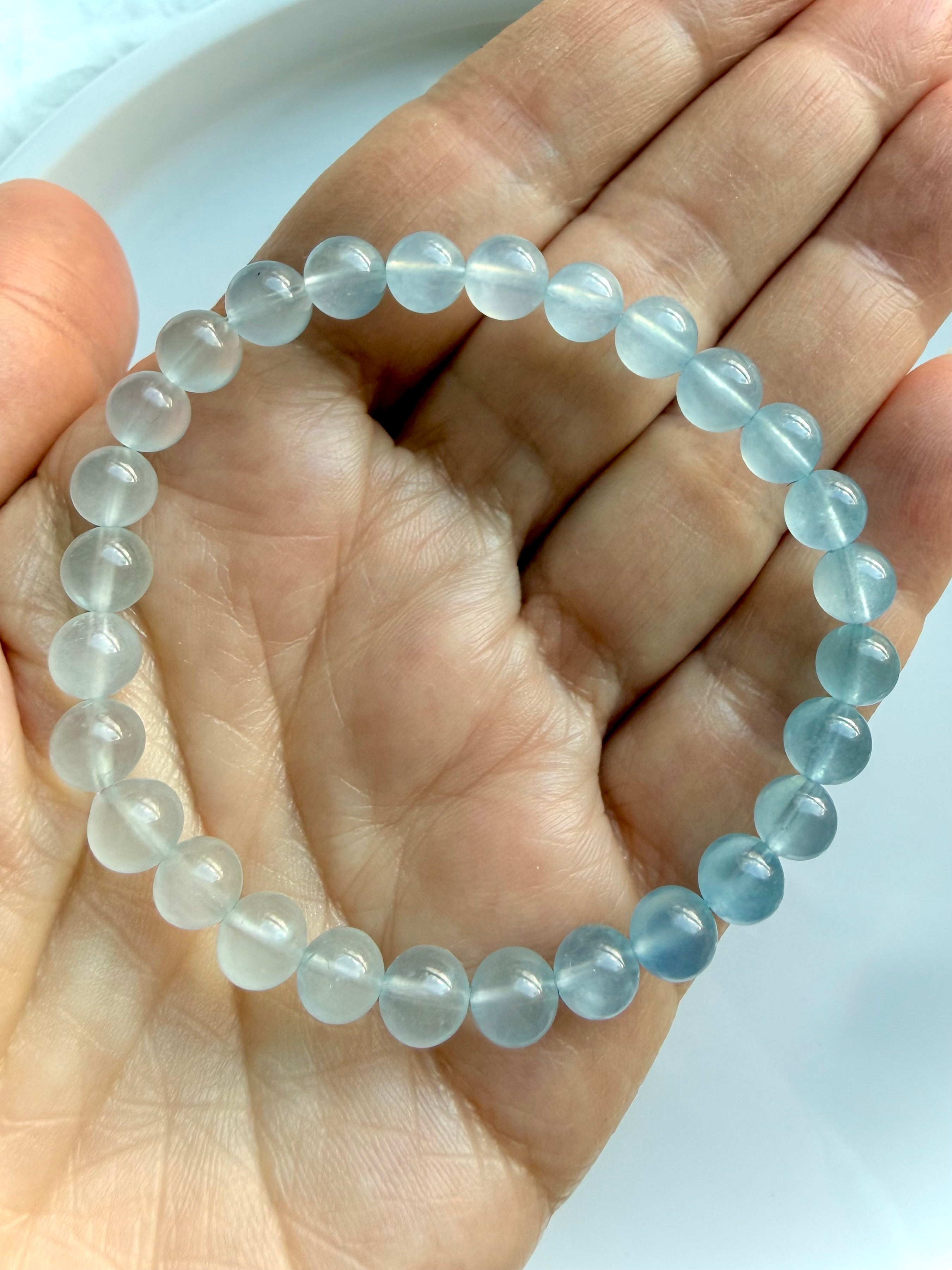 Close up view of March birthstone Aquamarine bracelet in luminous ombré blue gemstone beads