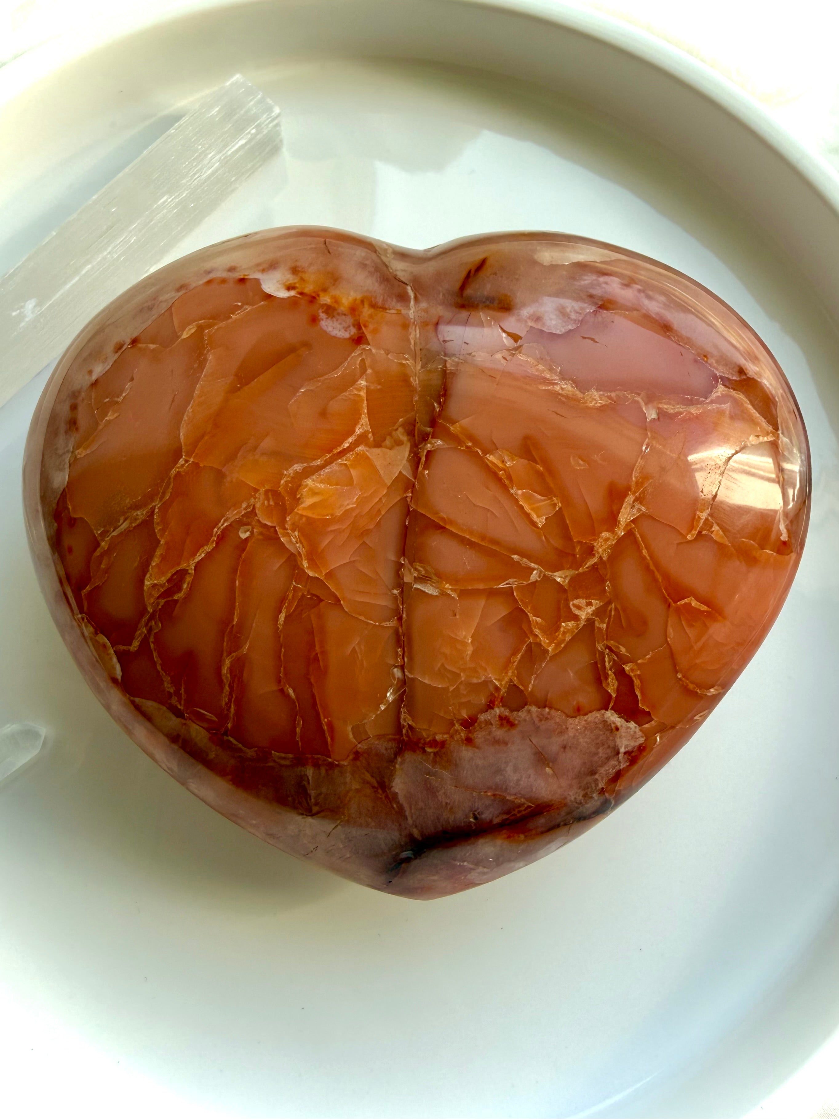 Large Carnelian geode heart shown in hand displaying sparkling druzy center and natural crystal beauty