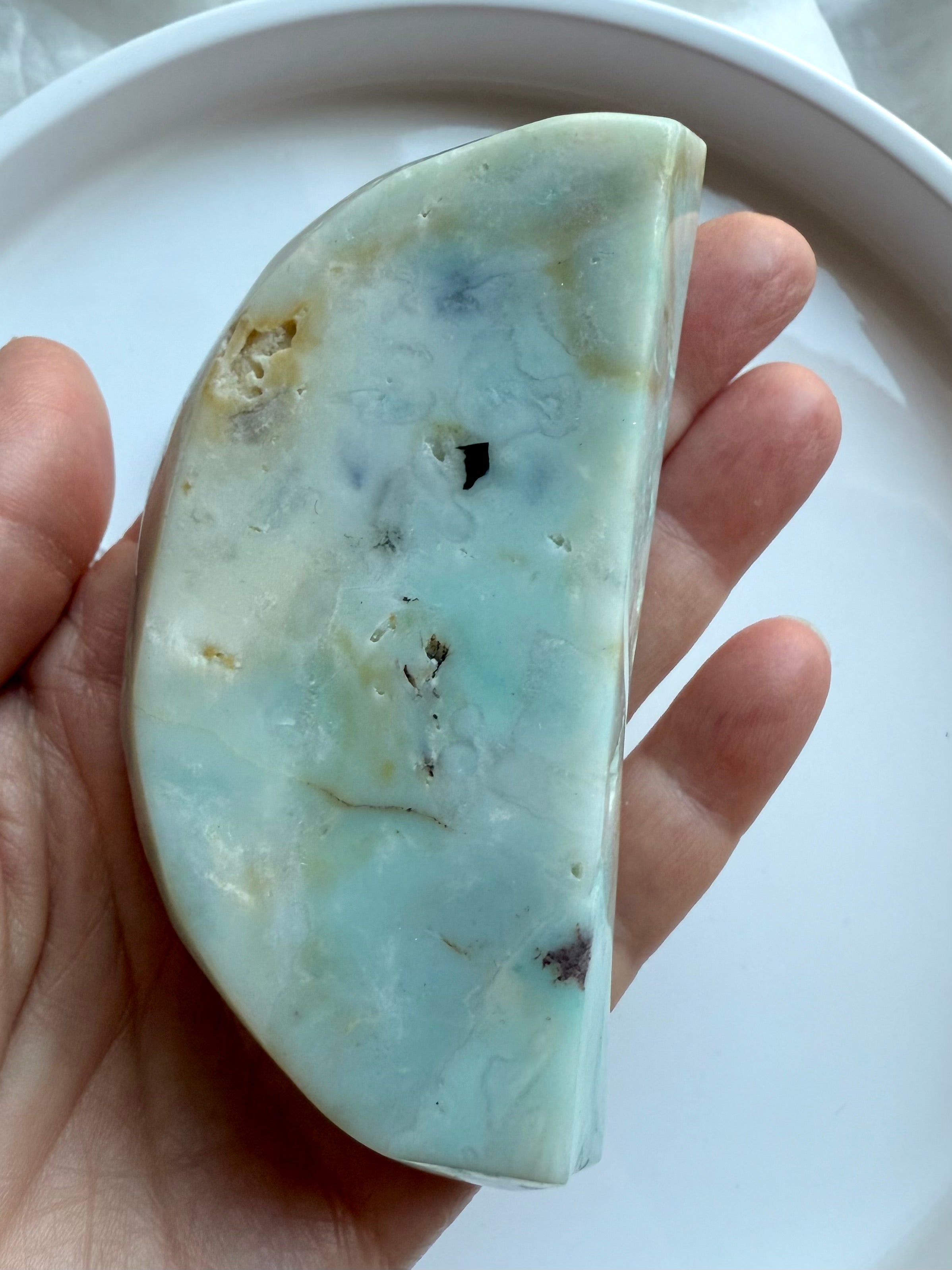 Sky Blue Quartz crescent moon bowl bottom view on palm