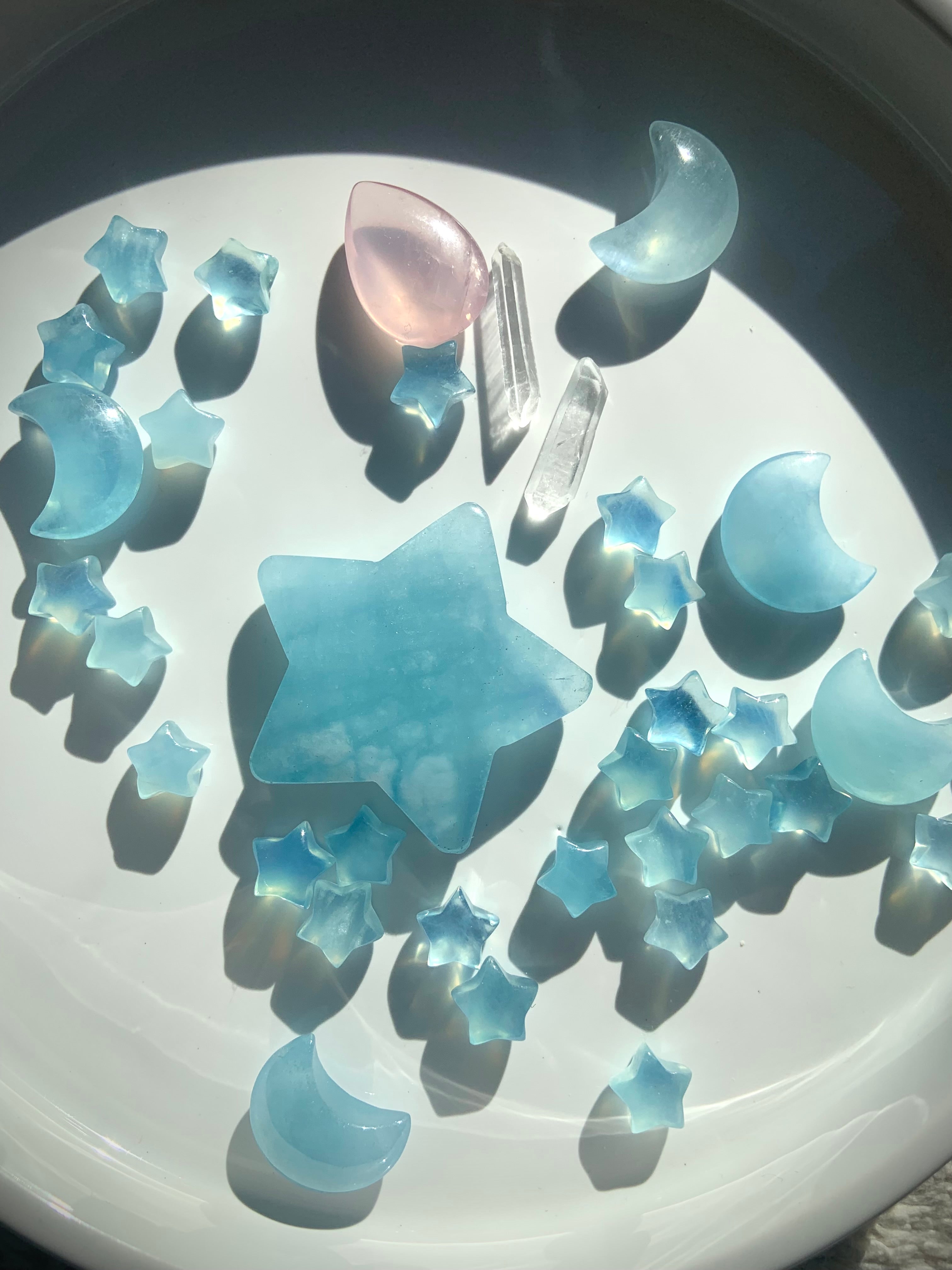 Luminous blue Aquamarine crystal carvings reflecting natural light