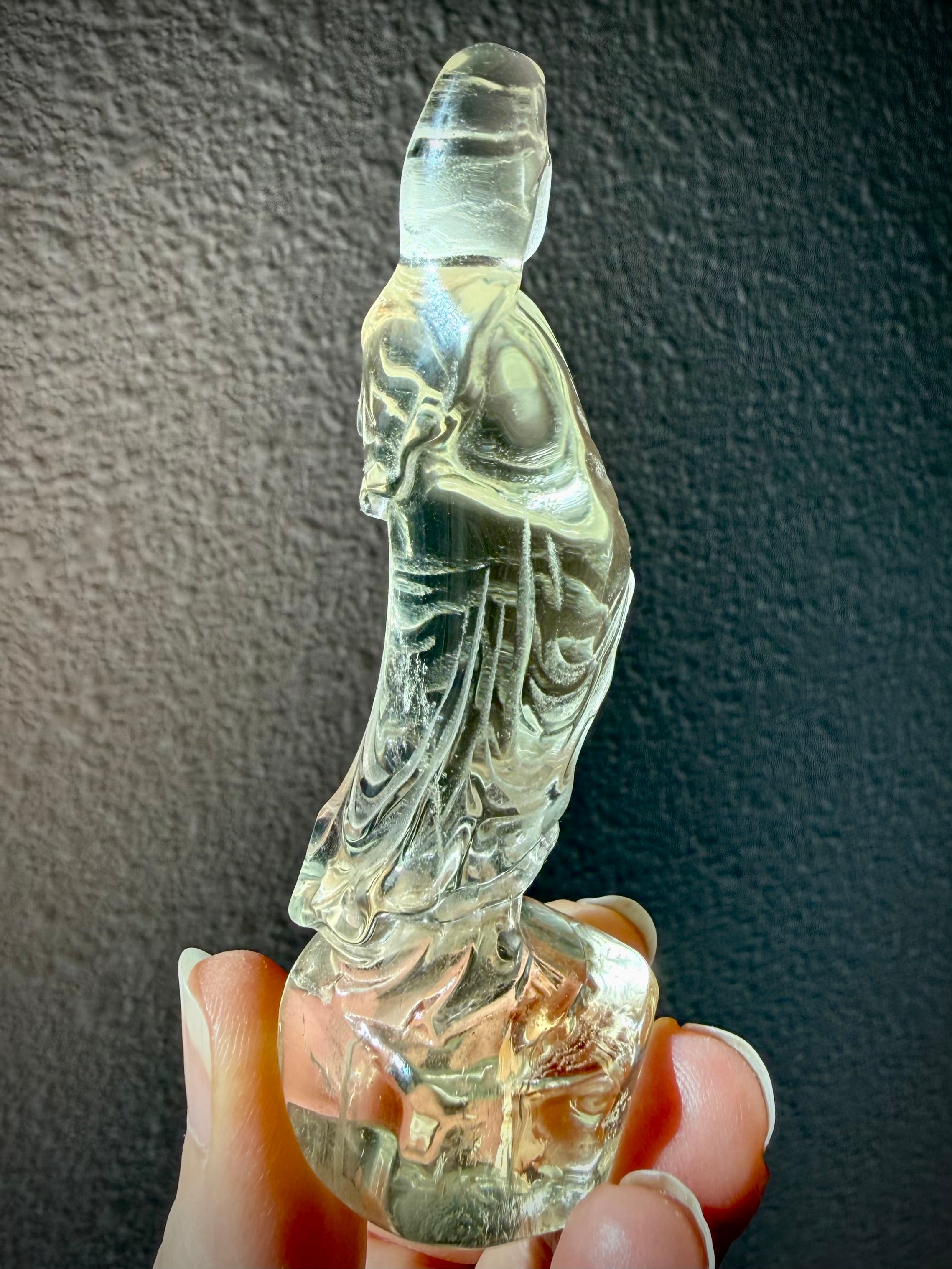 rear view of natural Citrine Quan Yin statue highlighting carved robe details and crystal clarity