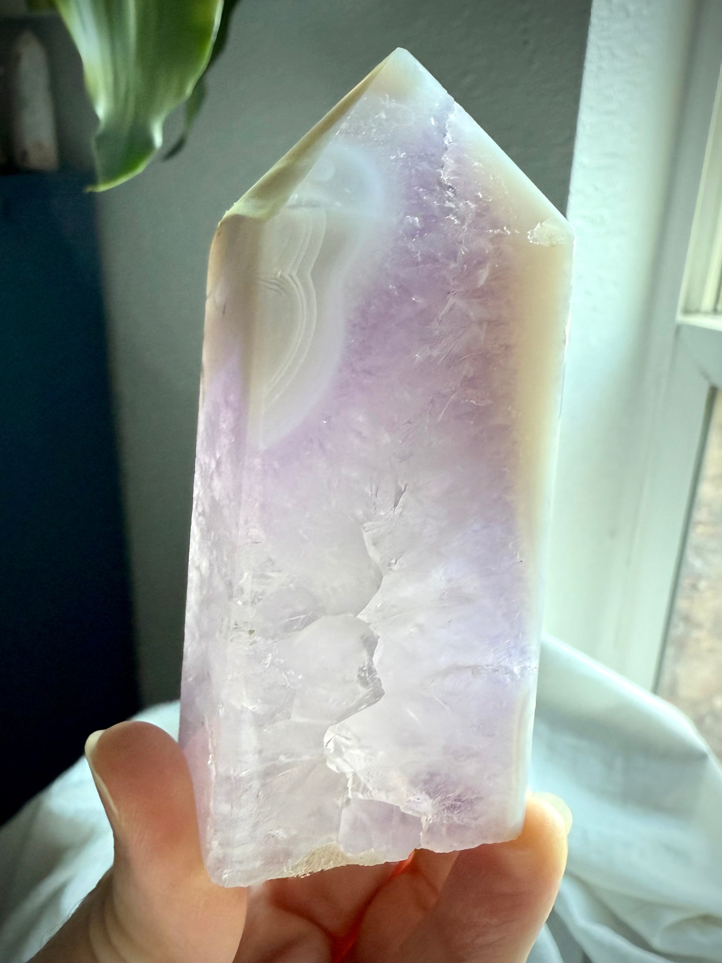 Backlit view of polished Amethyst and Agate Tower with quartz inclusion and soft purple hues