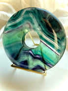 Rainbow fluorite donut on gold stand crystal peace buckle display piece