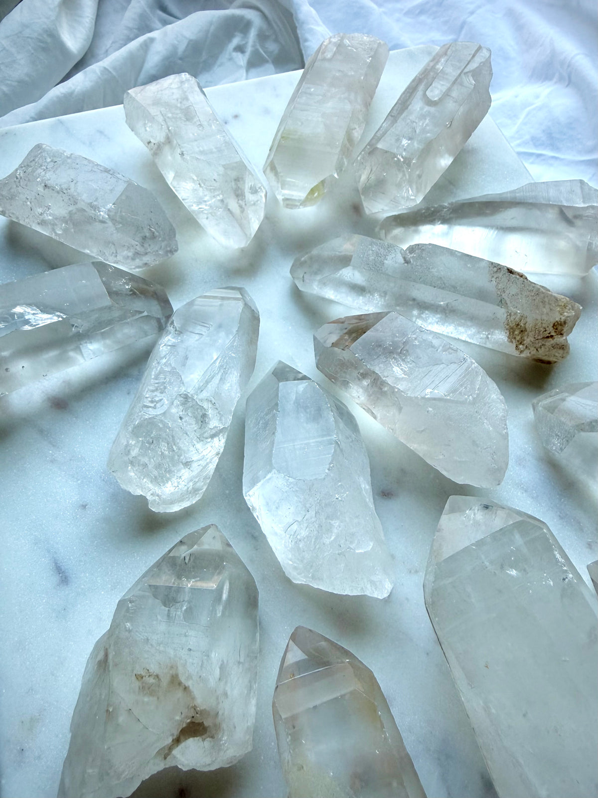 Chunky Lemurian Quartz points with varied natural terminations, rough surfaces, Clear Quartz, and cloudy mineral inclusions