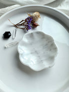 White marble daisy bowl with scalloped edges, styled empty with dried flowers and crystals
