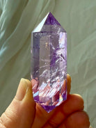 Faceted Amethyst Vogel crystal wand from Brazil with rainbow inclusions and luminous color