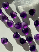Gemmy Amethyst hearts with a quartz point on white — mini purple crystals for spiritual healing