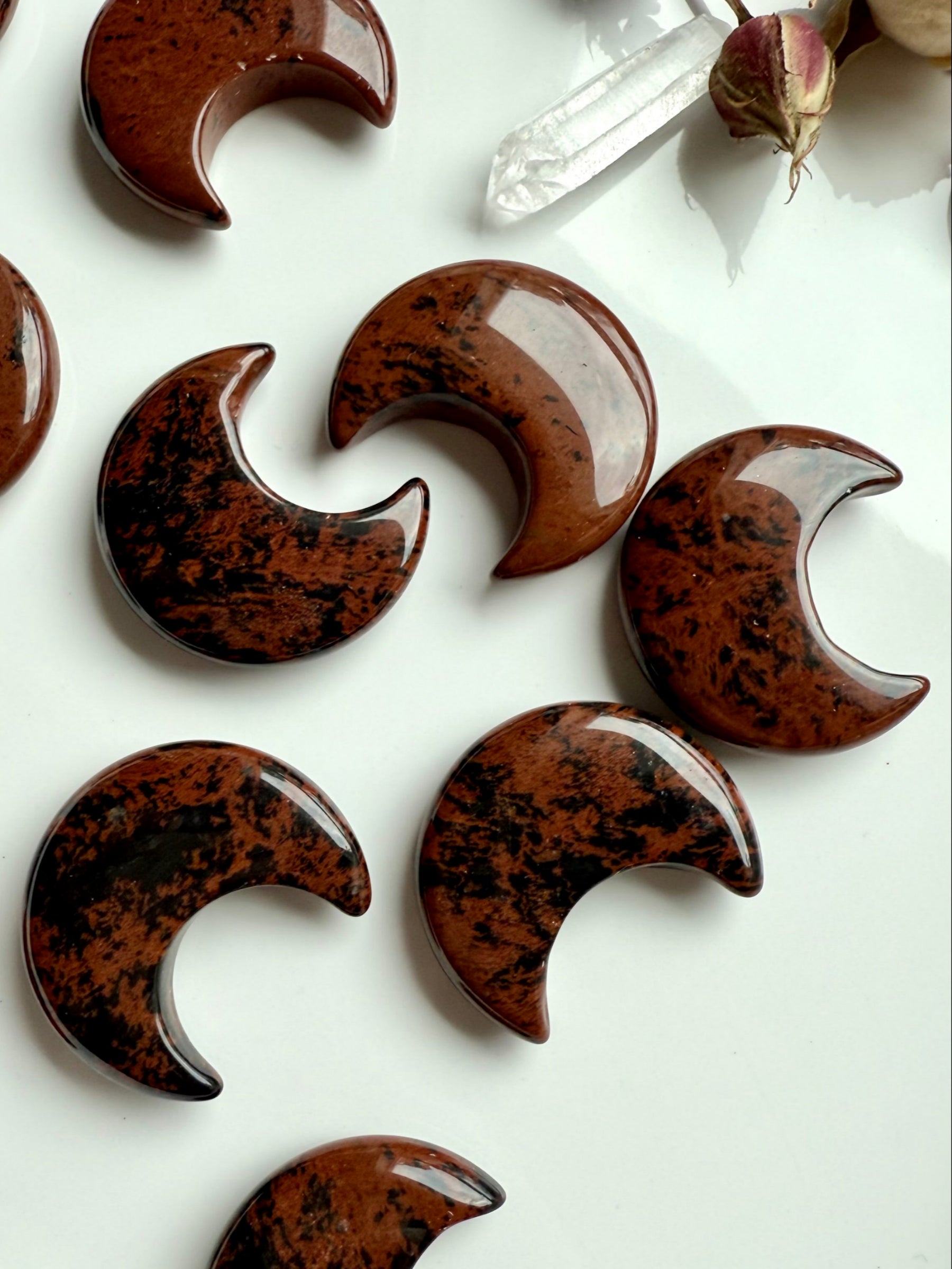Macro shot of Mahogany Obsidian crescent moons showing glossy polish, roch colors, & unique patterns