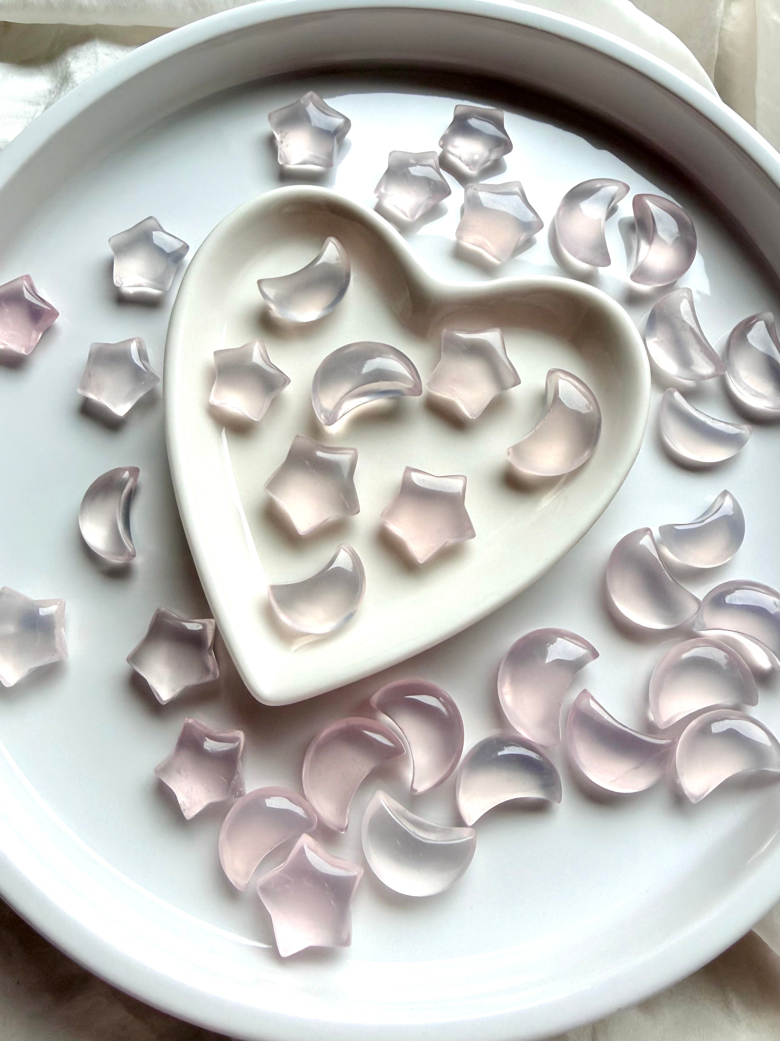 Mini Rose Quartz moons and stars arranged in a heart bowl, crystals for love and emotional healing