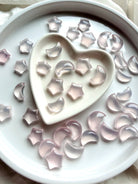 Mini Rose Quartz moons and stars arranged in a heart bowl, crystals for love and emotional healing