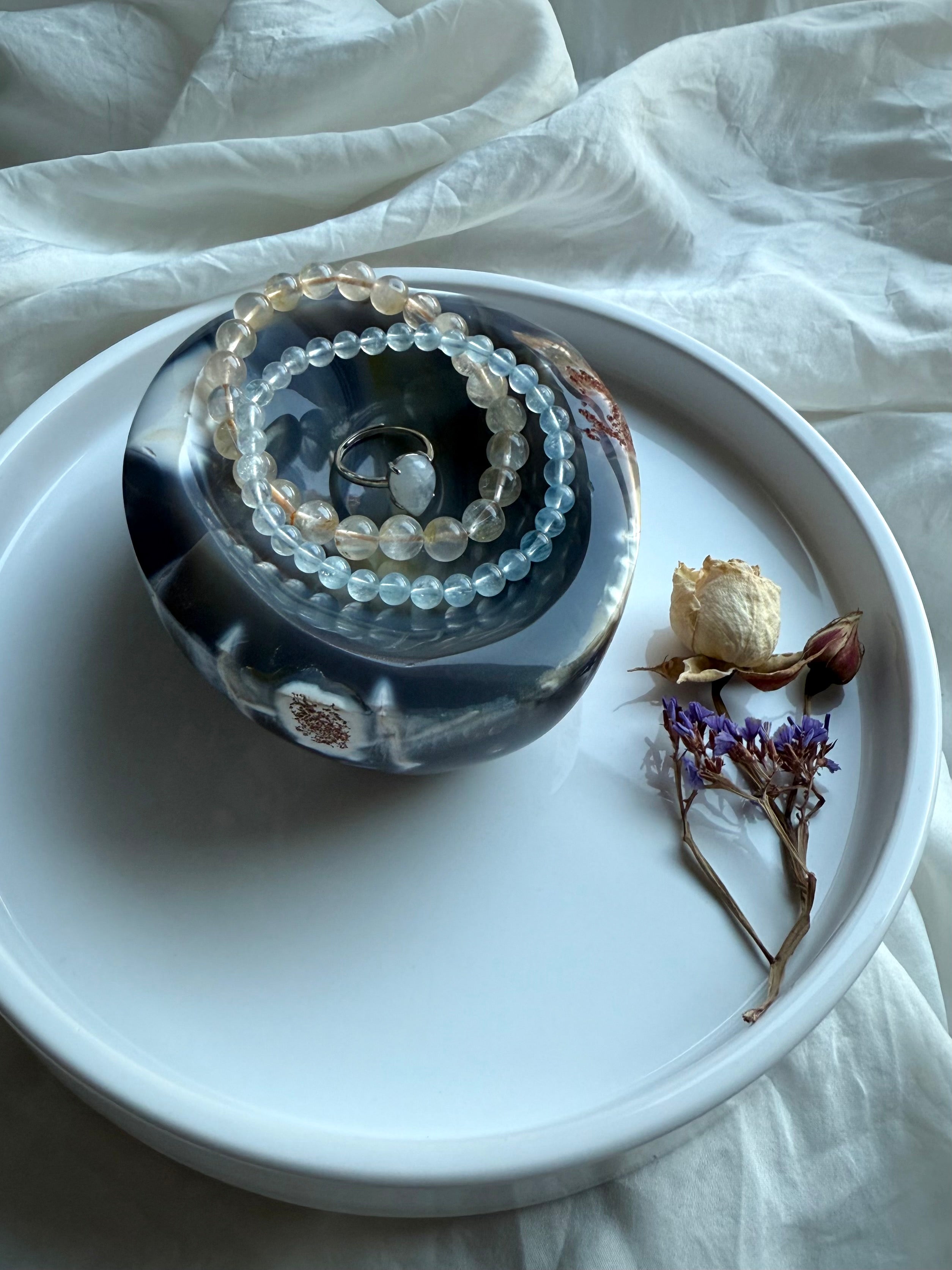 Orca Agate offering bowl styled with gemstone bracelets and a ring — hand-carved crystal dish for jewelry, offerings, and sacred altar display.
