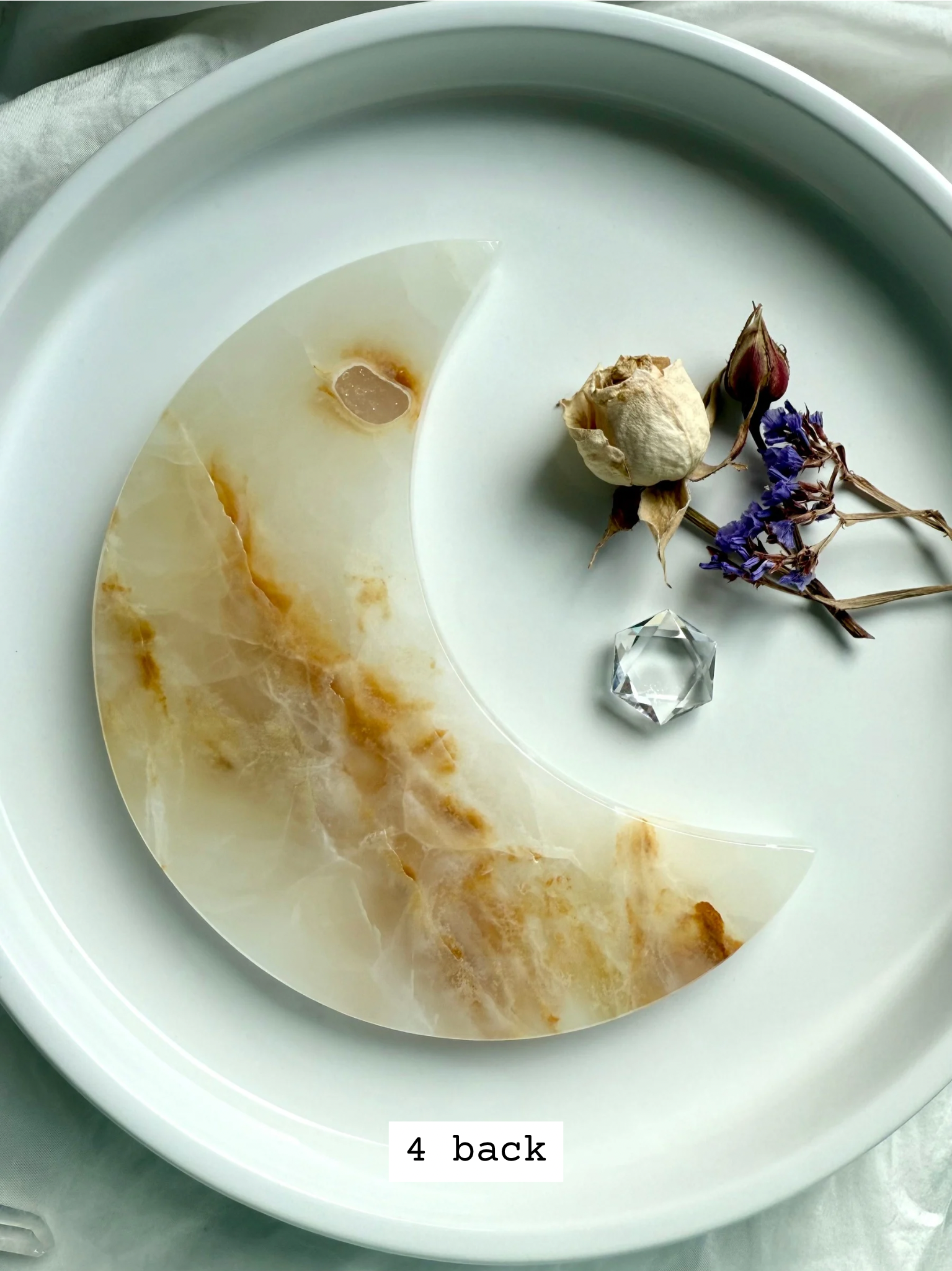White Onyx Crescent Moon Plate, soft creamy ivory with warm golden hues, back view.