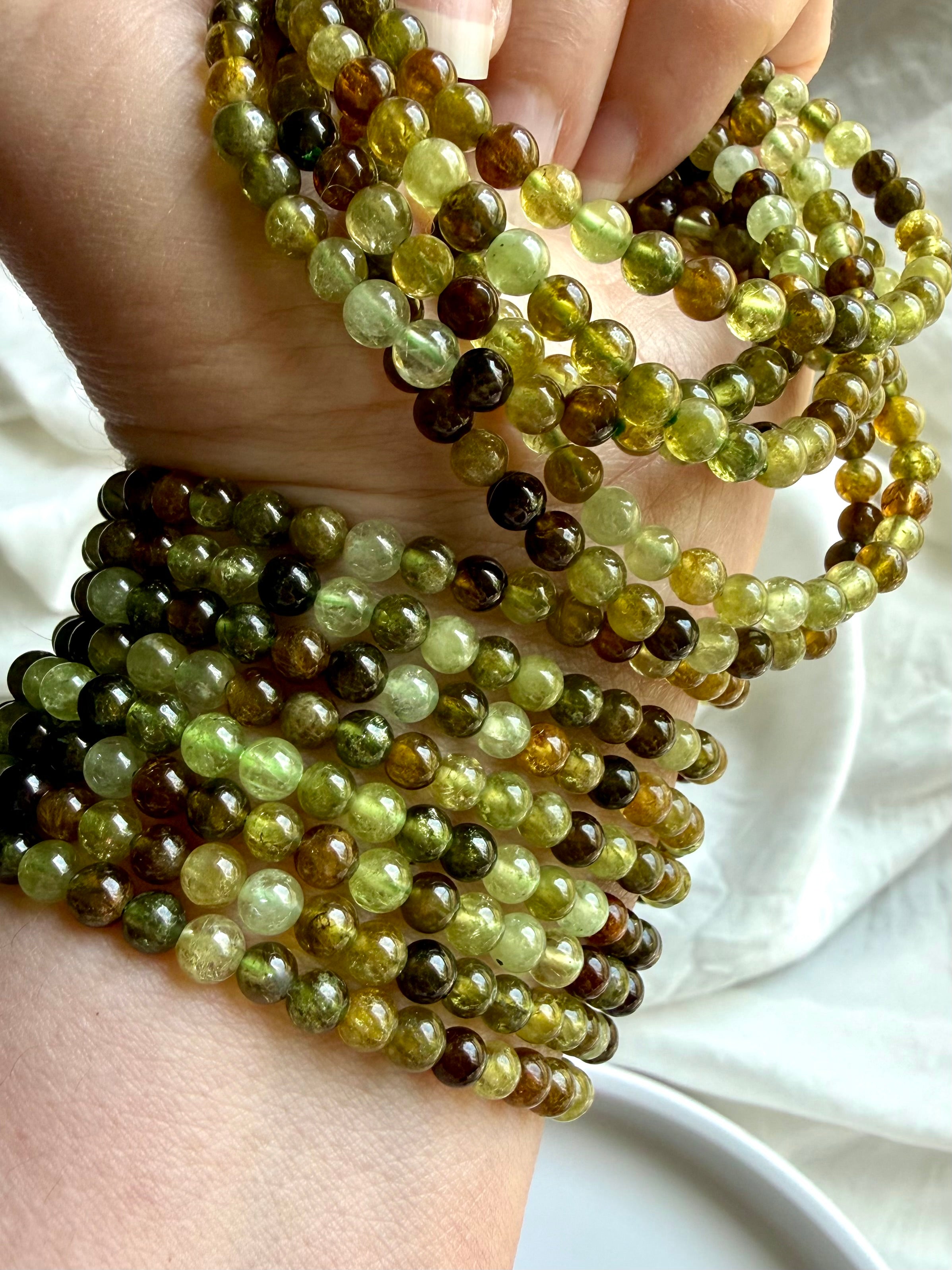 Tsavorite Garnet bracelets with luminous green gemstone beads in olive, chartreuse, amber, and deep forest tones
