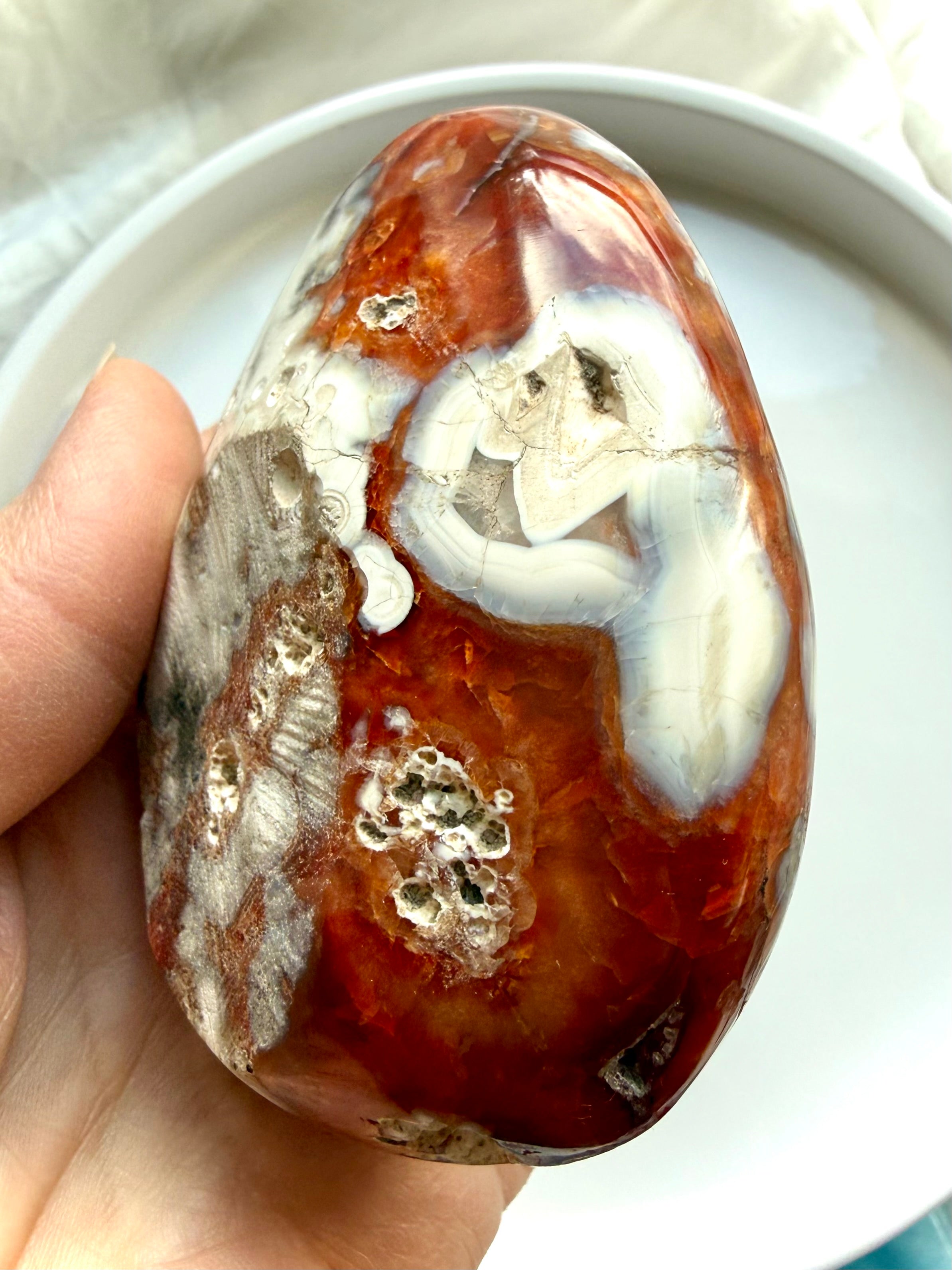 close up of carnelian bowl with orca agate inclusions and natural mineral texture
