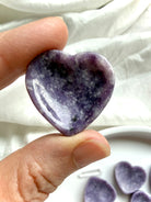 Mini Lepidolite heart bowl held in hand showing shallow heart-shaped dish for rings, earrings and tiny treasures
