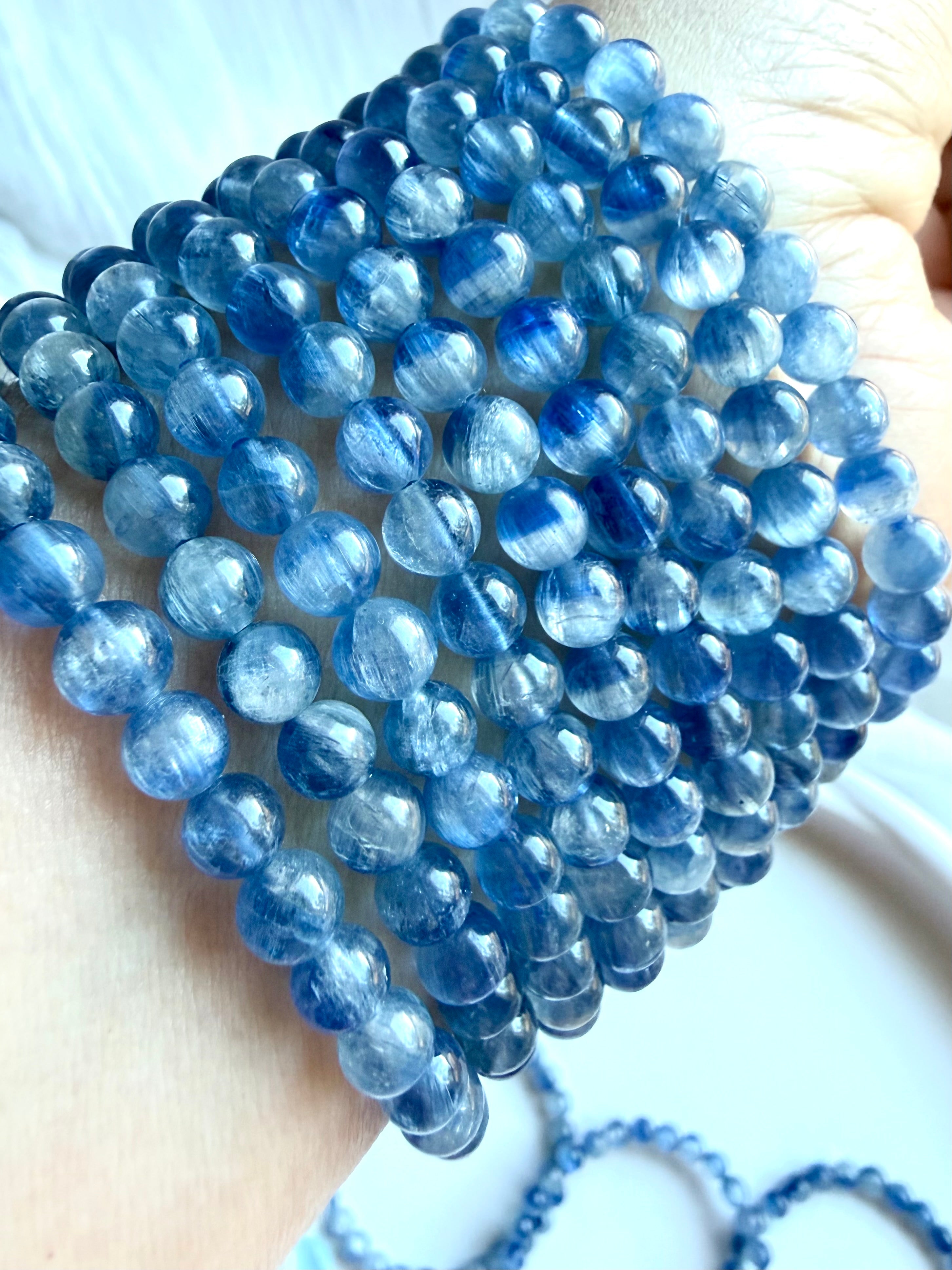 Blue Kyanite bracelet close-up showing two-tone blue gemstones with soft watercolor-like variation
