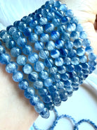 Blue Kyanite bracelet close-up showing two-tone blue gemstones with soft watercolor-like variation