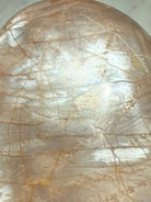 Close-up of Peach Moonstone freeform showing luminous silver flash, natural crack lines and warm peach orange coloring