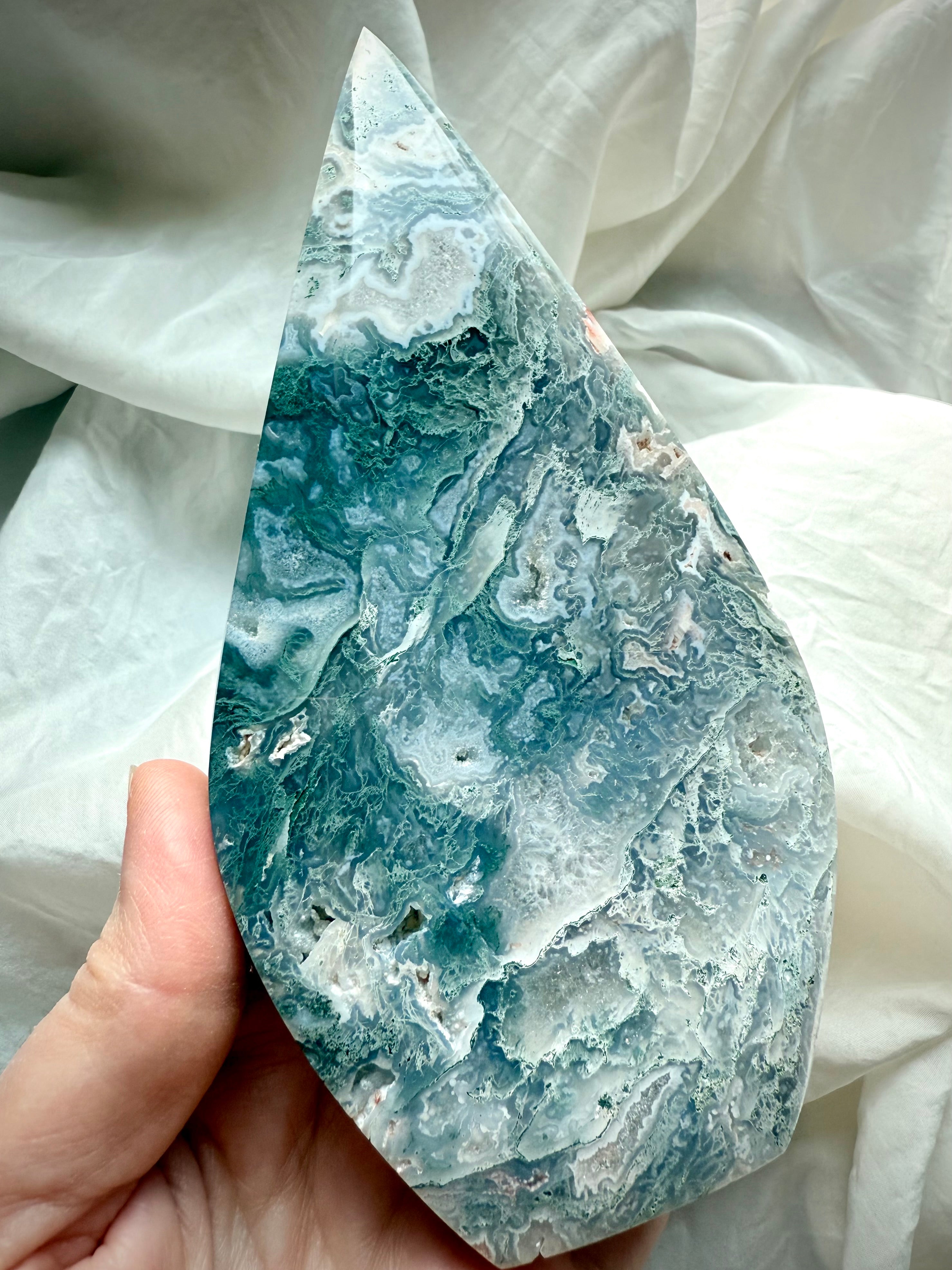 Icy teal moss agate flame close-up with lacy agate formations and sparkling quartz druzy inclusions