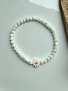 Single Mother of Pearl daisy bracelet styled in circle on white background – shell bead bracelet with flower focal bead