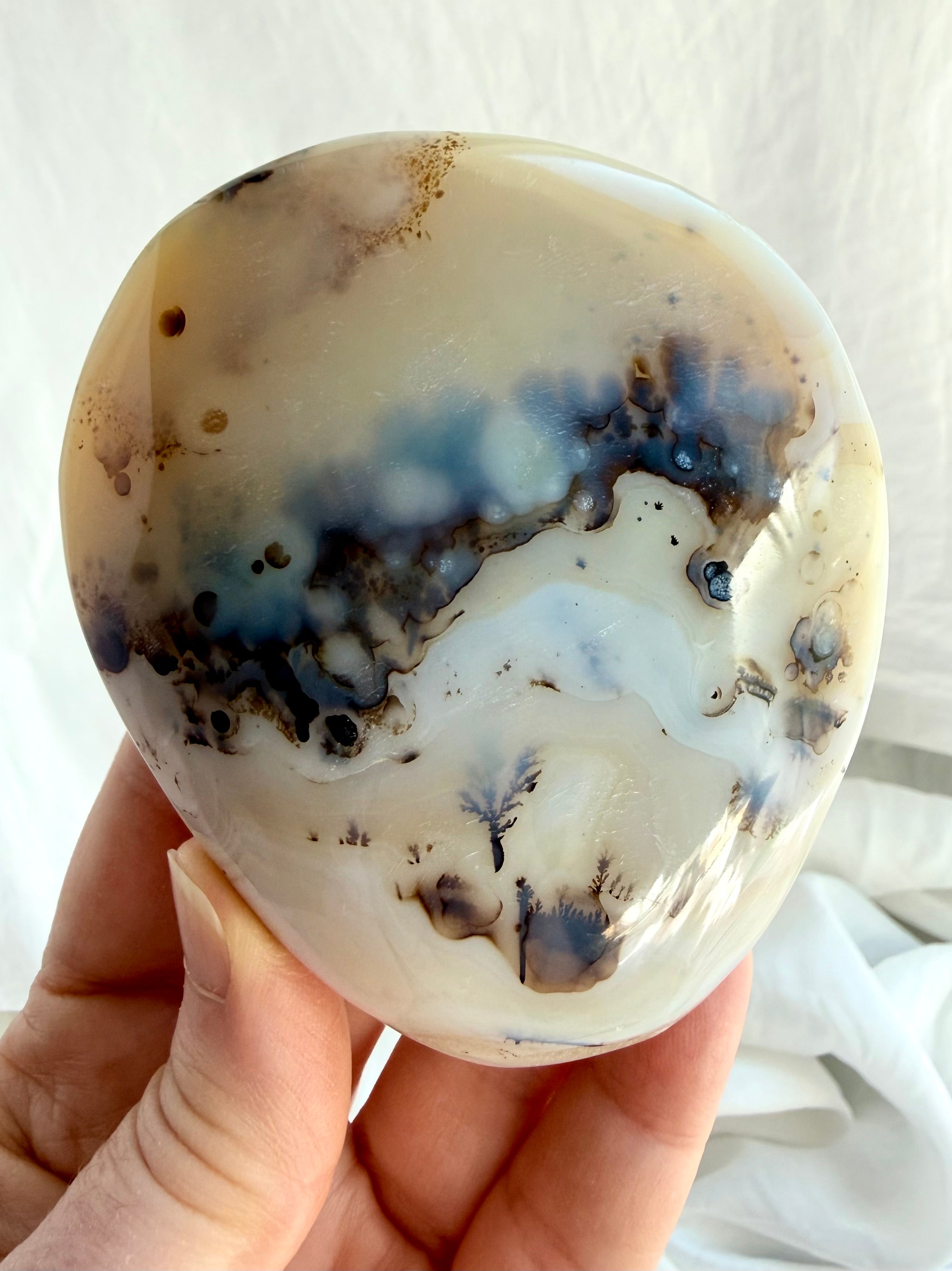 Close-up of polished Dendritic Agate freeform with distinctive black mineral formations, creamy white Agate and natural banding