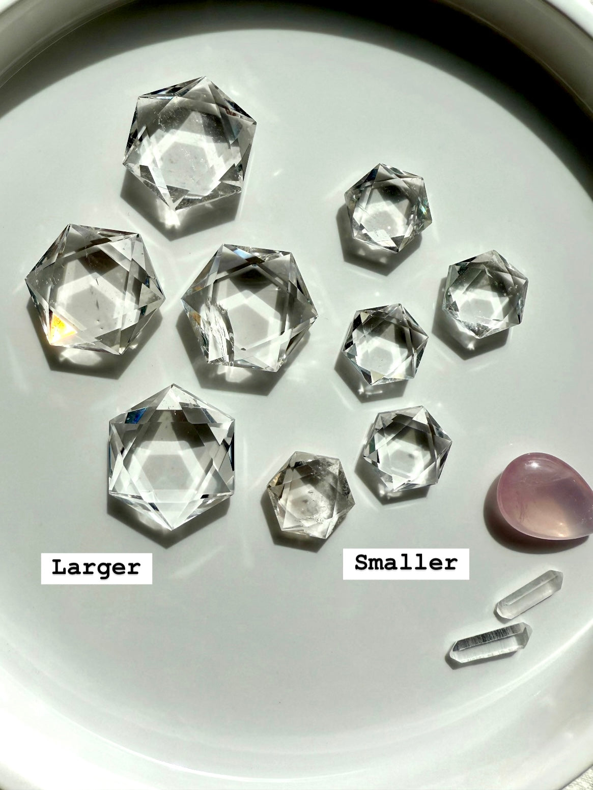 Overhead array of Clear Quartz hexagons in both sizes, smaller and larger marked for comparison