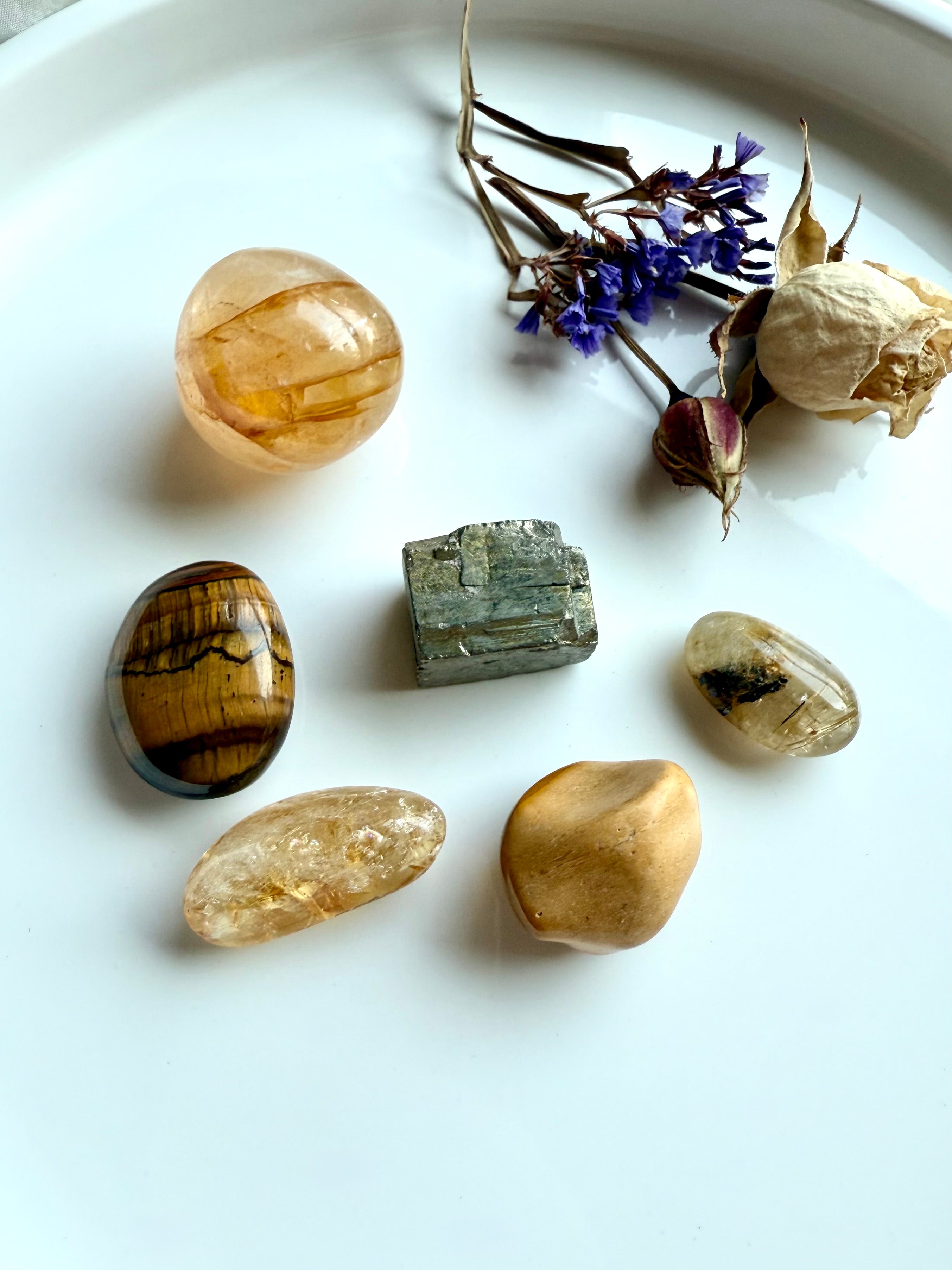 Solar Plexus Chakra crystal set with golden healer, citrine, golden rutile, tiger’s eye, yellow mookaite, and pyrite styled with flowers