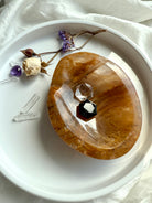 Golden Healer Quartz altar bowl displayed with clear quartz and small crystal hexagons inside