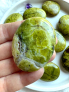 Macro view of Green Opal palm stone patterns — luminous chartreuse tones with natural inclusions and crackle textures.