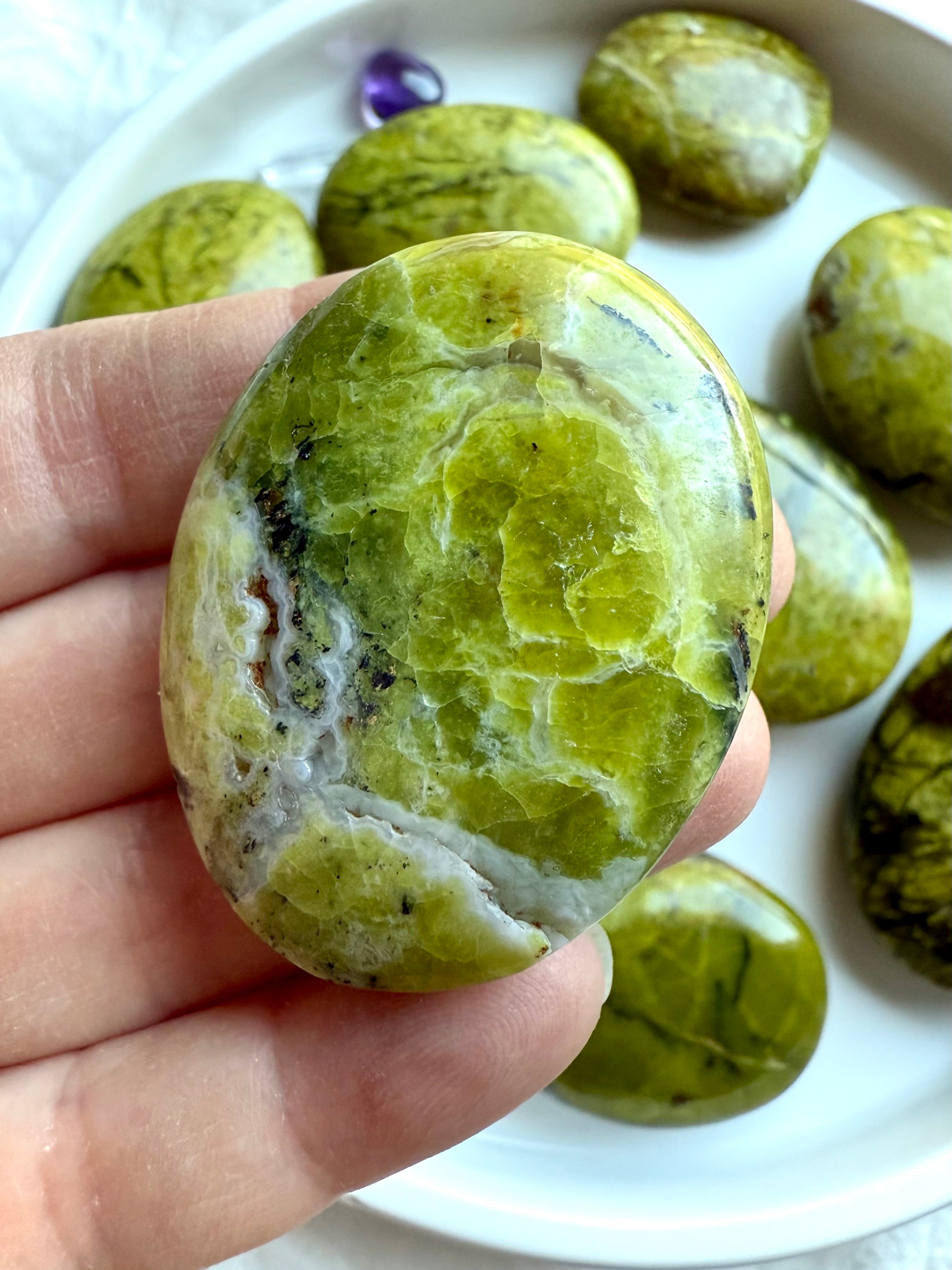 Macro view of Green Opal palm stone patterns — luminous chartreuse tones with natural inclusions and crackle textures.