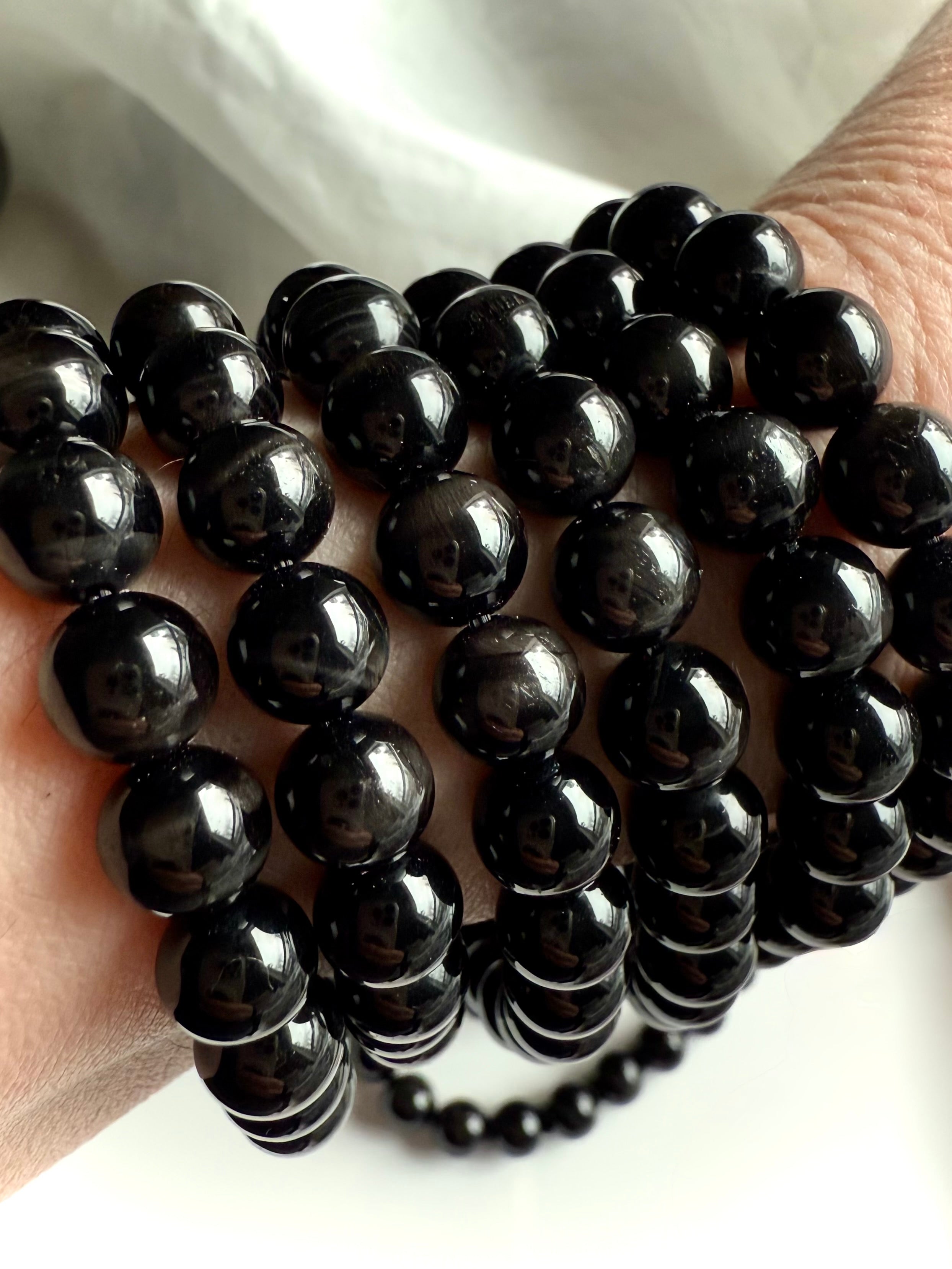Black Tigers Eye Bracelet made from glossy black beads with tiger eye striations + cat’s eye shimmer