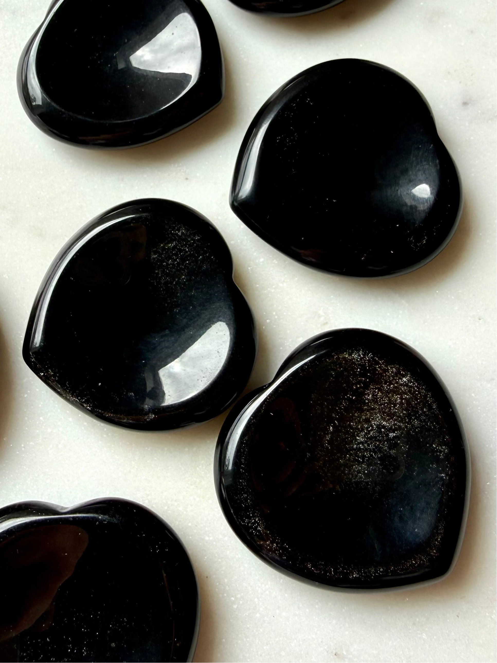 black obsidian heart worry stones set showing multiple pieces for grounding energy and stress relief