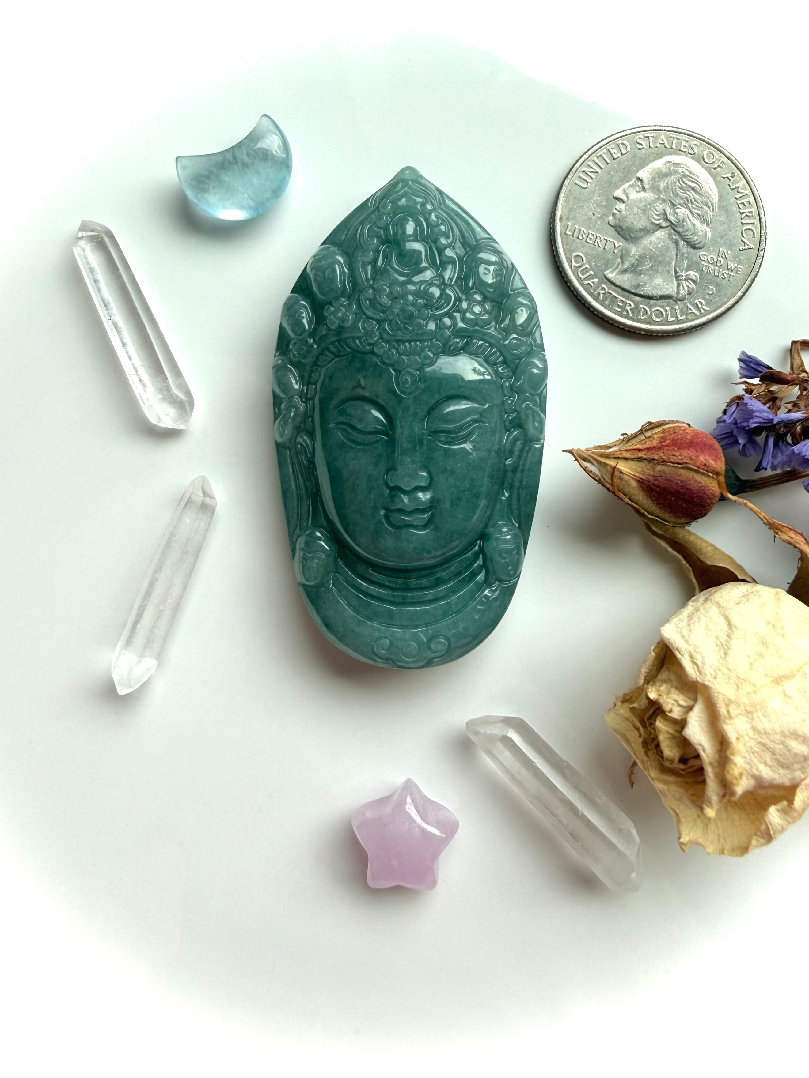 Blue Water Jade Quan Yin head carving in altar display shown next to a US quarter for size reference