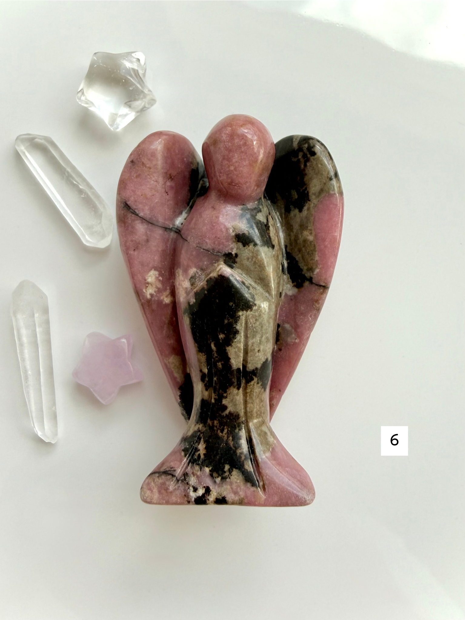 Natural Rhodonite angel carving with intricate matrix patterns and grounding energy