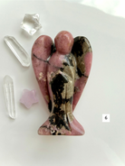 Natural Rhodonite angel carving with intricate matrix patterns and grounding energy