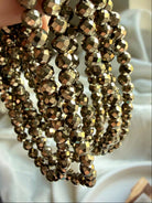 multiple faceted pyrite bracelets draped together highlighting golden metallic sparkle