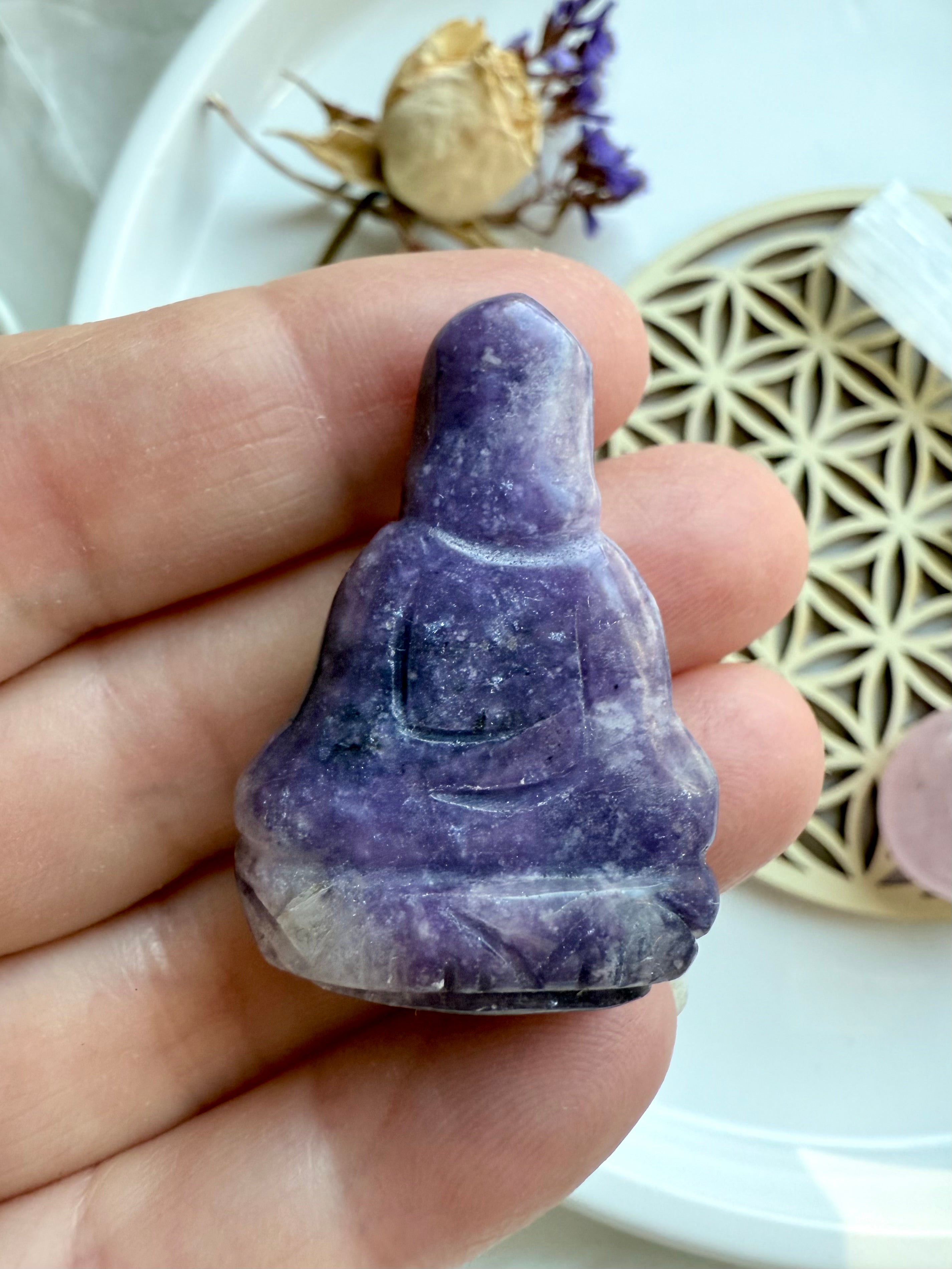 Rear view of lepidolite Quan Yin carving showing smooth stone texture and robe detail