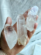 Large Lemurian Quartz point held in hand showing chunky natural formation, clear and cloudy Quartz, and rough surfaces