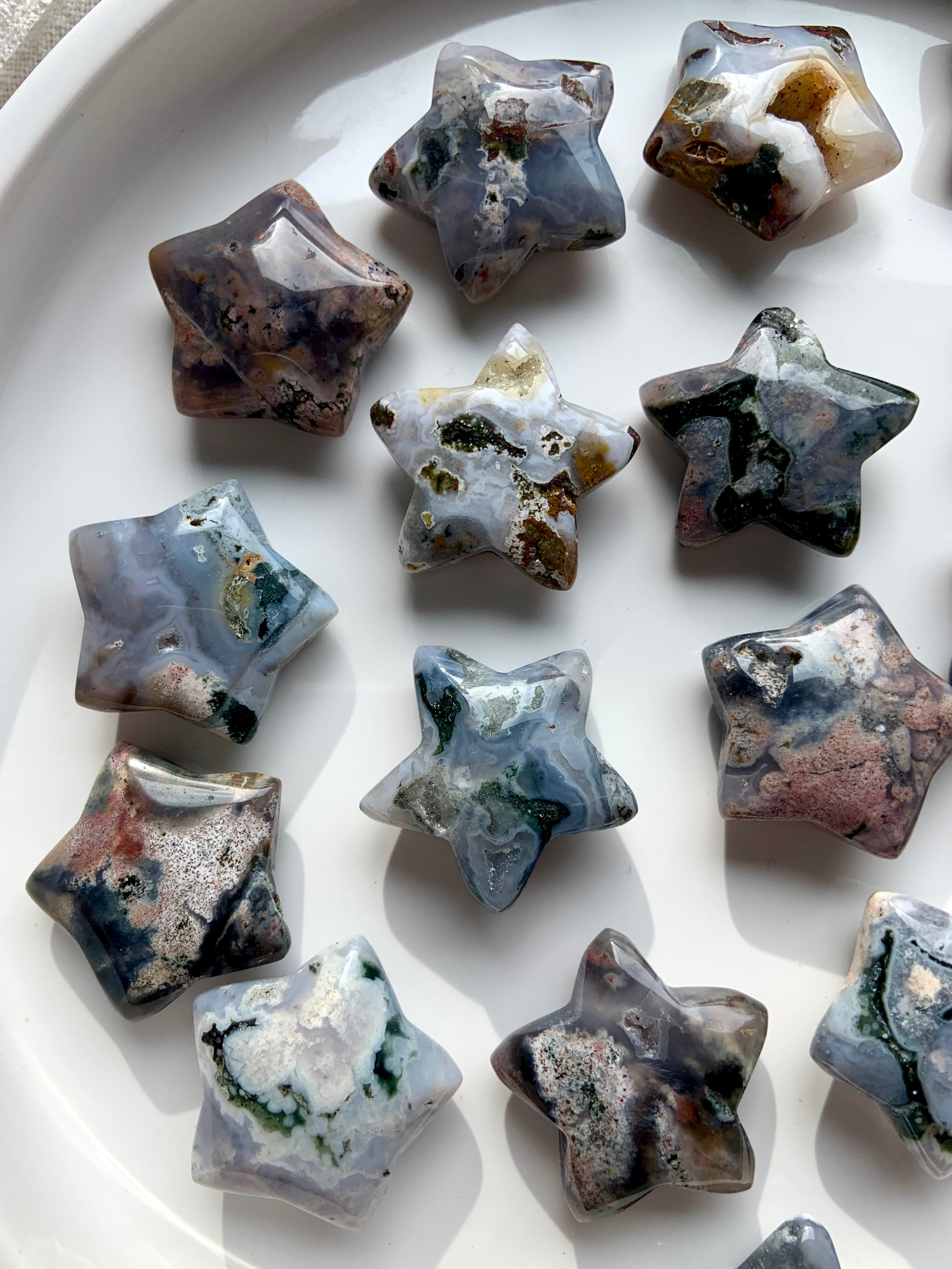 Cosmic Ocean Jasper star carvings on white background