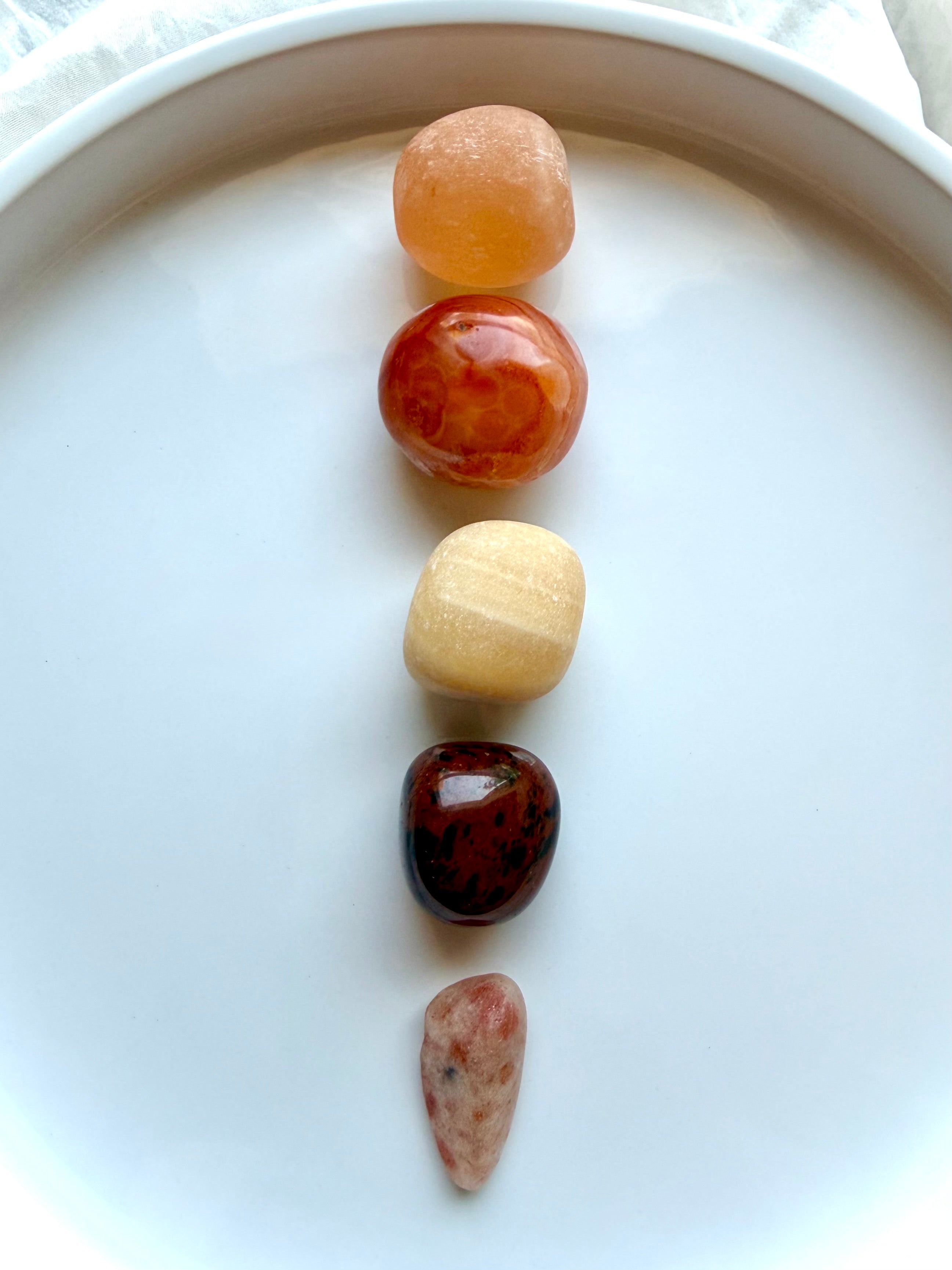 Five Sacral Chakra crystals arranged vertically for creativity, emotional balance, personal power, and energy healing
