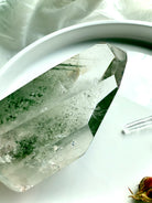 Side view of Garden Quartz Crystal tower with lush green chlorite phantom inclusions, silvery flash