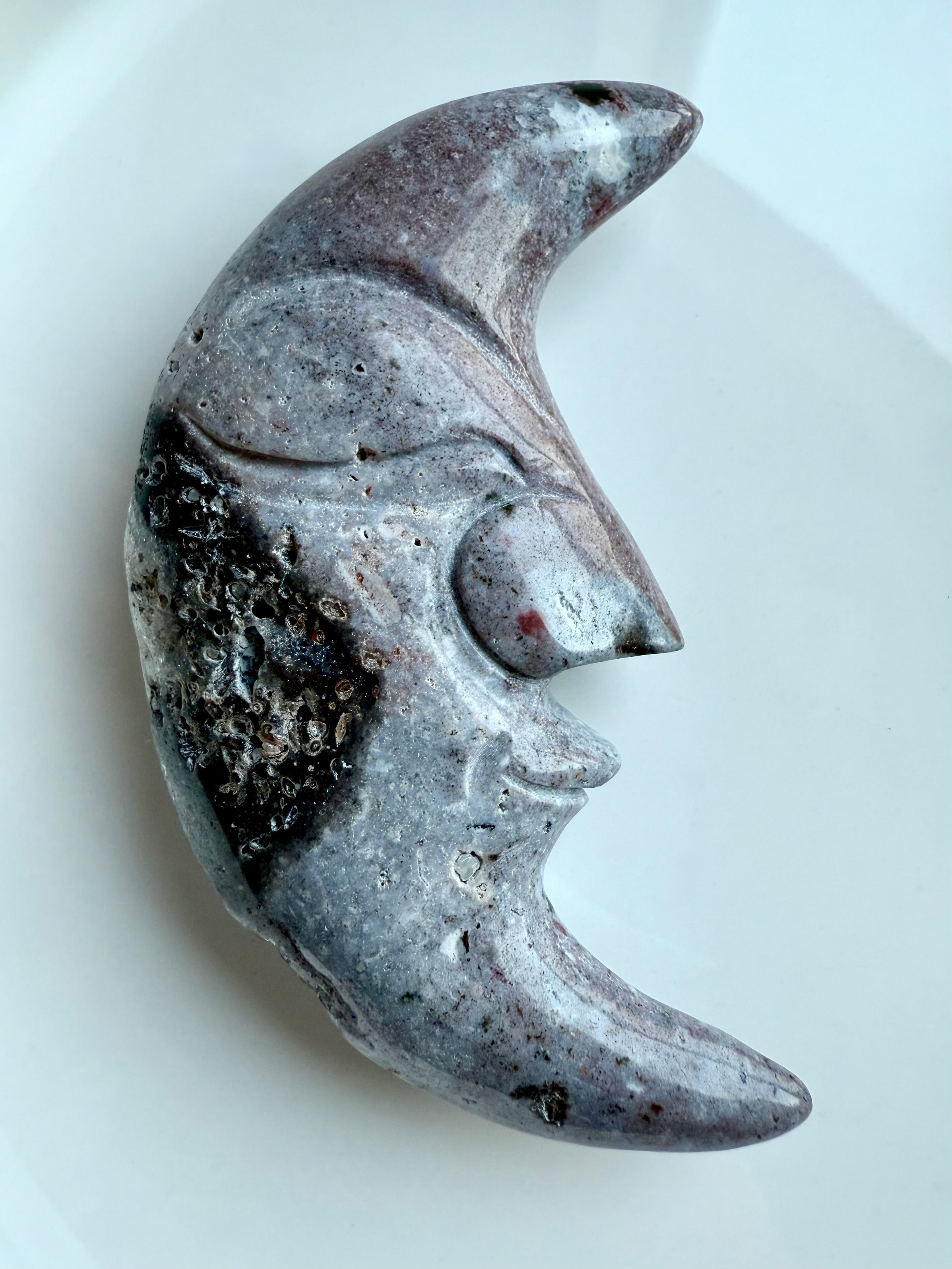 Polished Ocean Jasper moon face crystal in purple hues – carved gemstone with swirling inclusions.