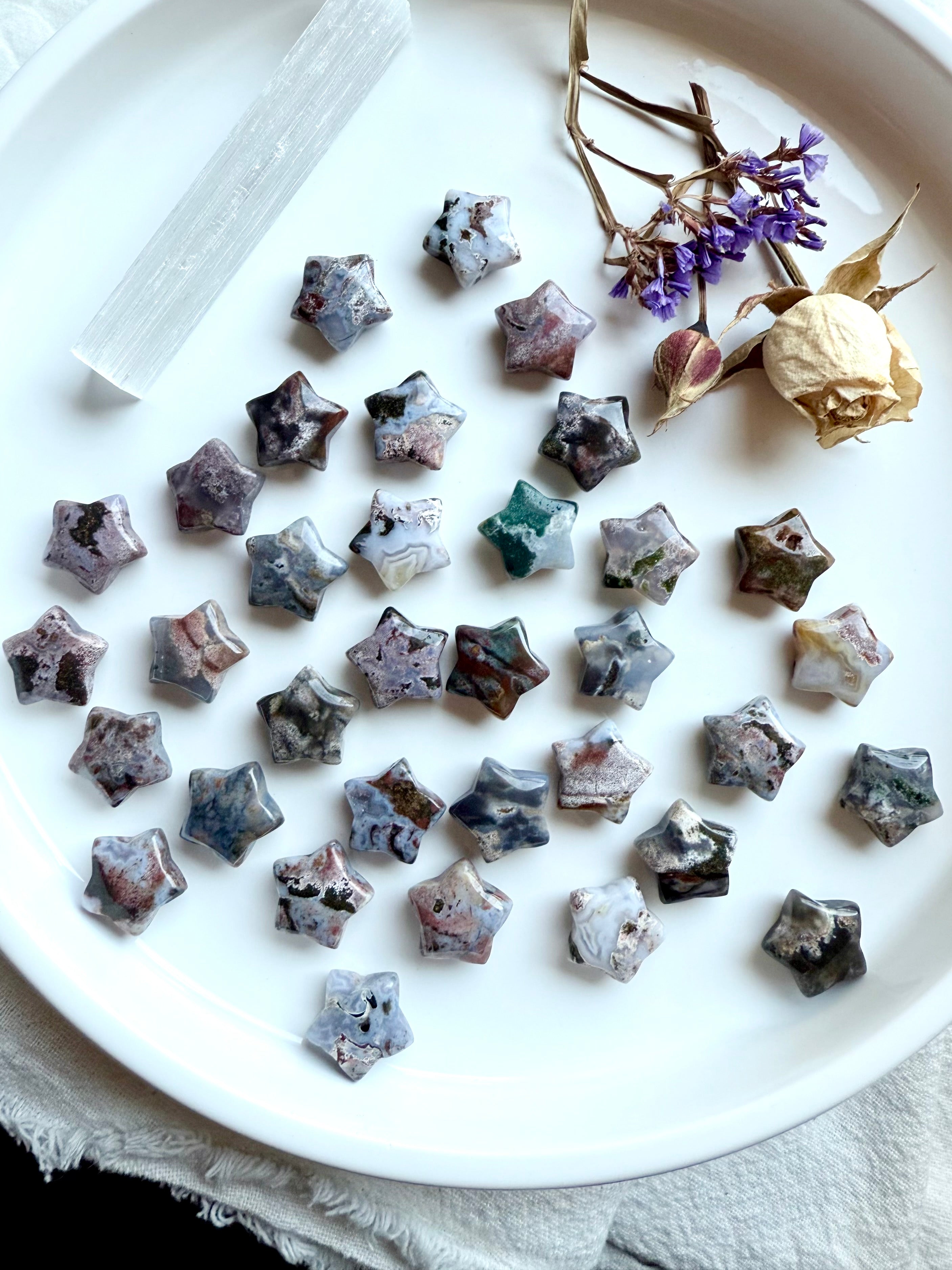 Ocean Jasper star carvings displayed with selenite and dried flowers, mini gemstone stars for healing, ritual, and sacred space decoration