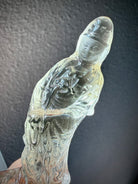 closeup of Citrine Quan Yin crystal carving with serene expression and translucent golden tones
