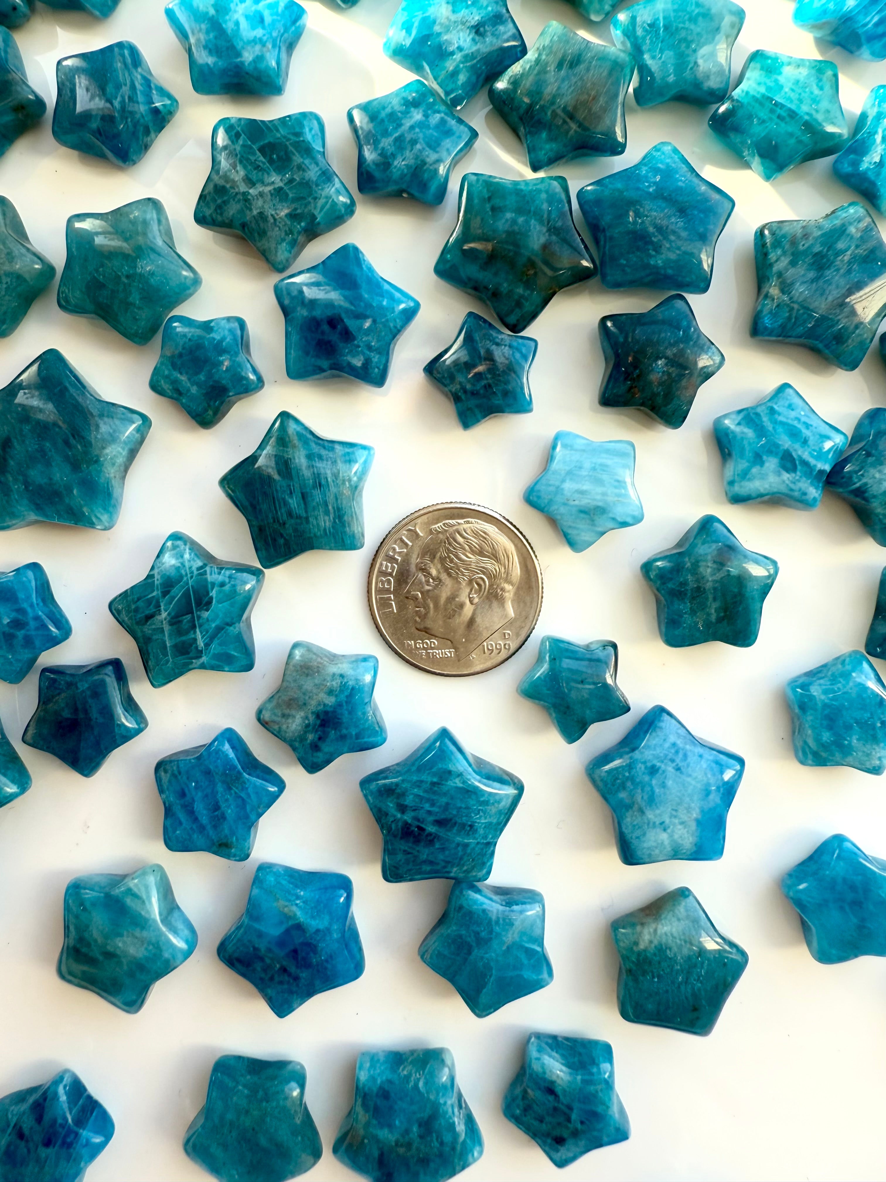 Blue Apatite mini crystal stars shown with a dime for scale — star-shaped teal crystals for spiritual clarity & self-expression.