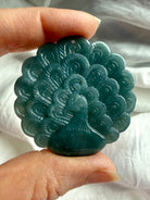 Blue Water Jade peacock medallion illuminated to reveal gentle translucence and natural marbling