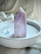 Polished Amethyst Geode Tower with white agate edge displayed on white ceramic tray